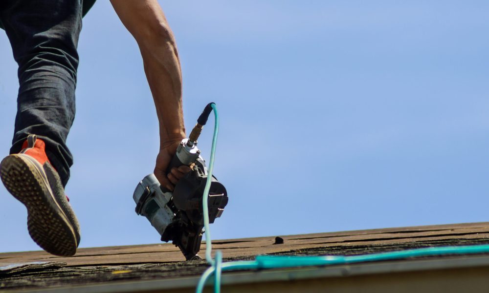 Roofers working on replacing the house installed new shingles